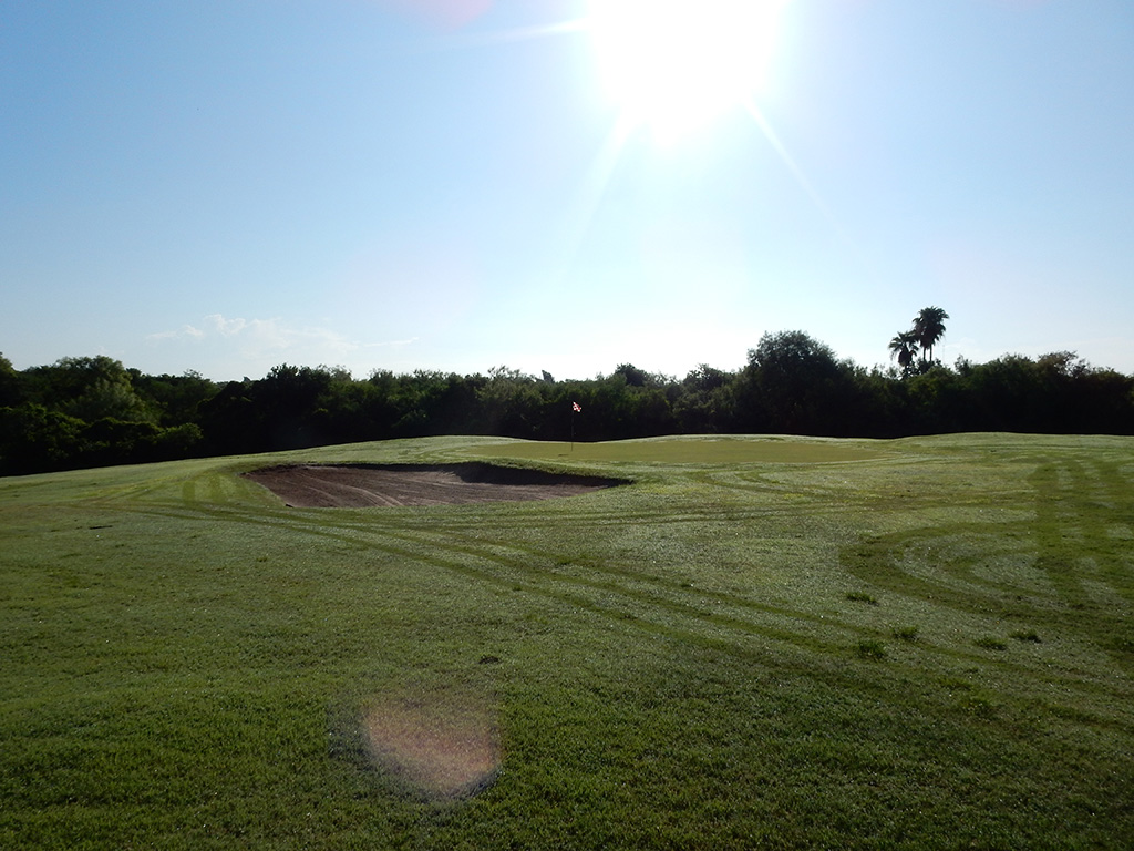 Golf course with bright sun and sand trap