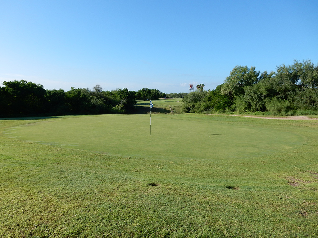 Golf course with trees in background